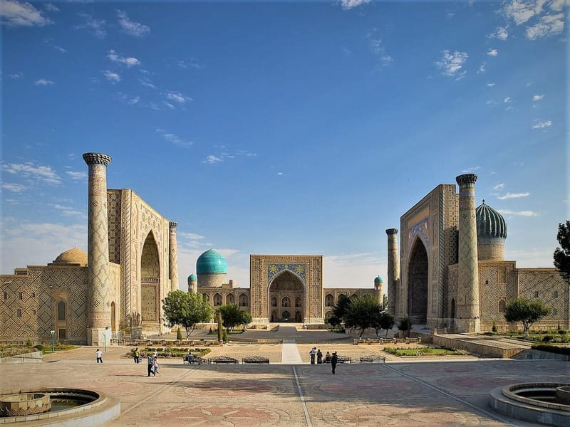 Registan Square in Samarkand, its turquoise tiled madrasah facades rising under a clear sky